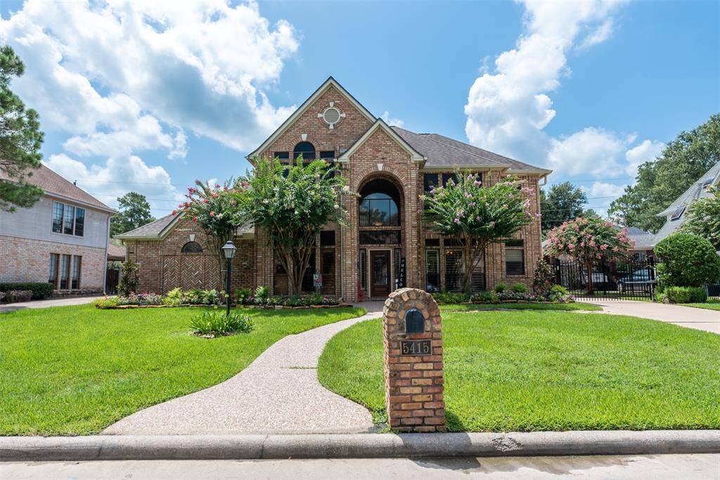 This beautiful two-story home features a classic brick exterior. It includes a spacious two-car detached garage and a well maintained front yard with lush greenery, offering great curb appeal!