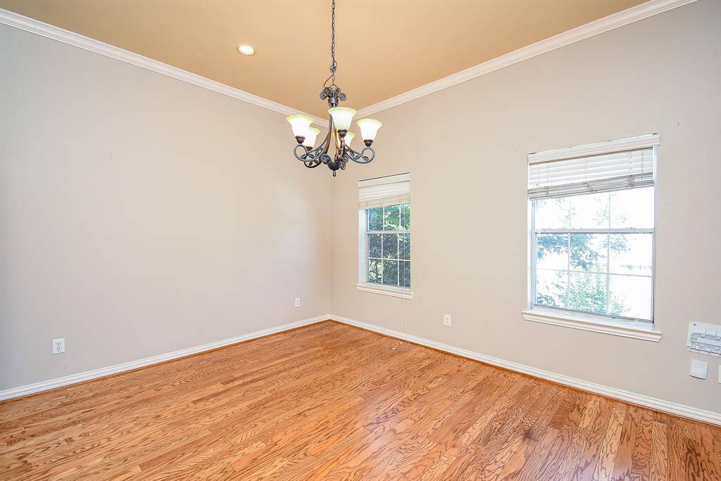 Bright and open living space leads into an adjoining kitchen area through double doors.