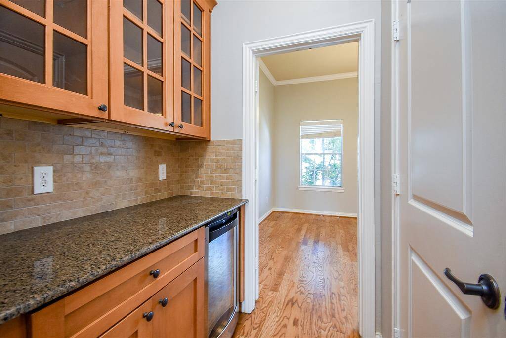 This kitchen offers ample storage, with an open layout extending into the living area and dining space.