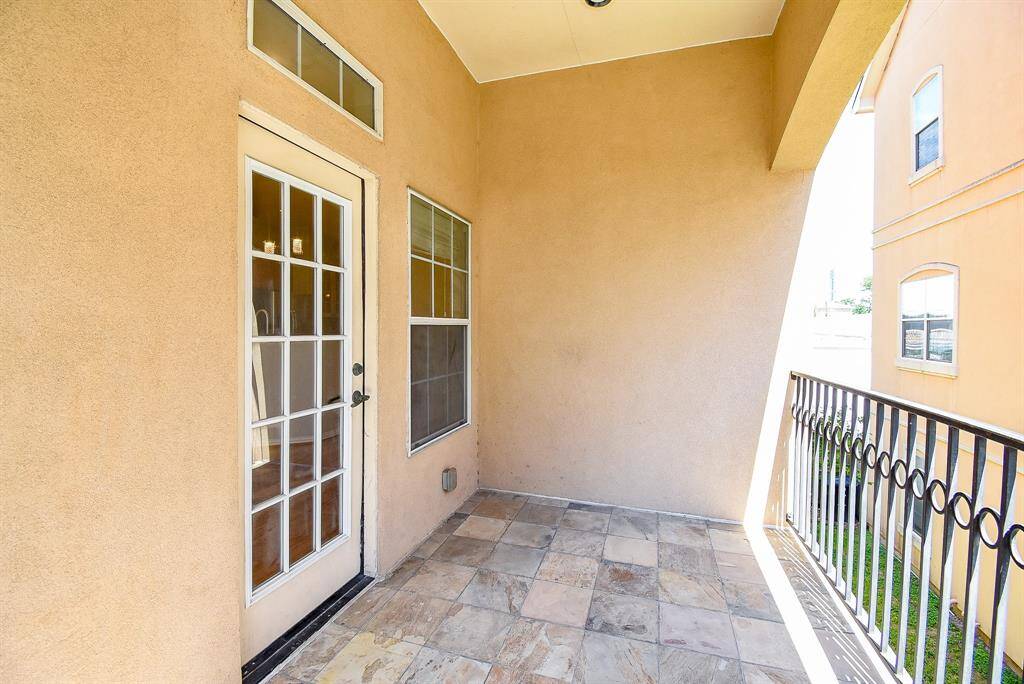Bright, spacious bedroom with neutral walls and carpet, featuring a ceiling fan and recessed lighting. It includes a closet with double doors and an en-suite bathroom with modern finishes.