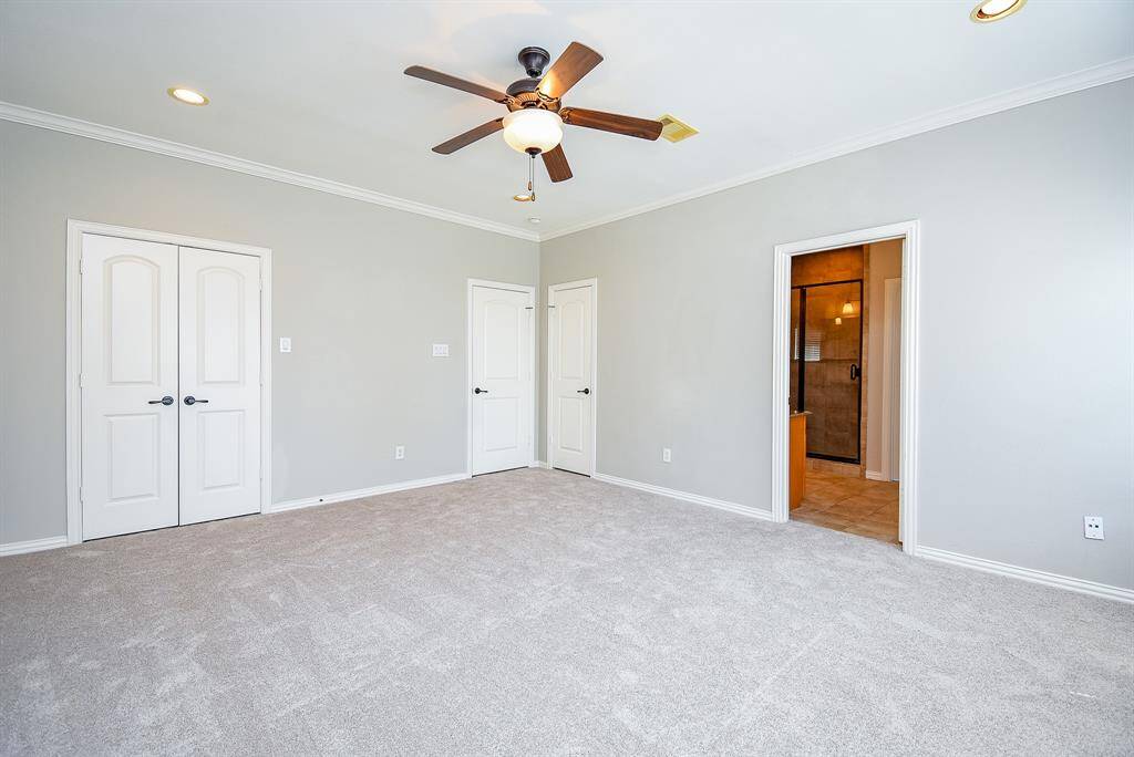 The primary bathroom features a cozy bathtub with tiled walls, a sleek granite countertop, warm lighting.