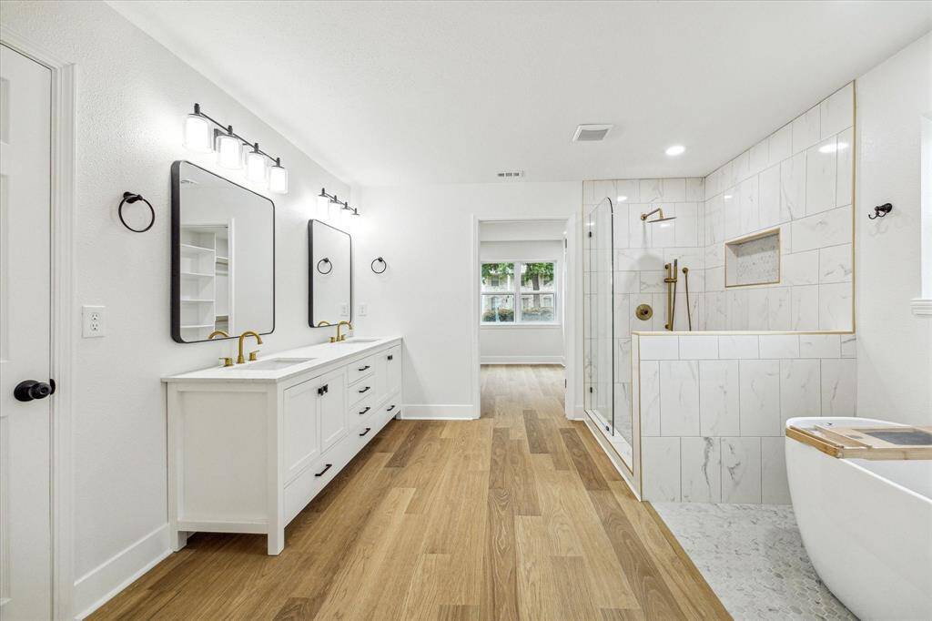 Primary en-suite featuring elegant finishes, deep soaker tub and huge walk in shower
