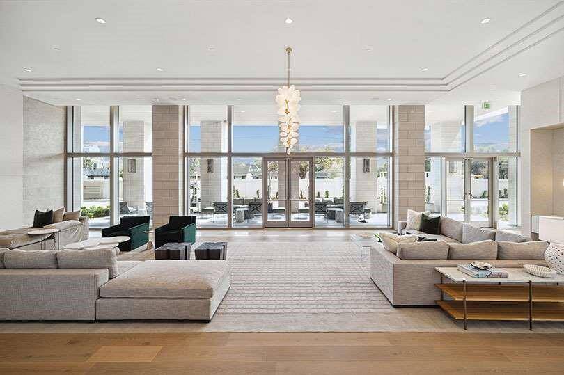 Lauren Rottet Studio brings this spacious, elegant lobby with abundant natural light and stylish seating areas to life with her design work.