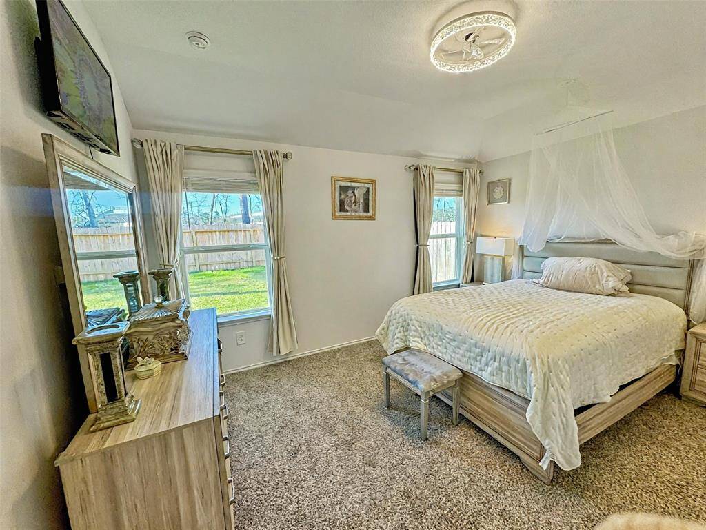 Generously sized bedroom with 2 inch faux blindsPrimary bedroom overlooks backyard