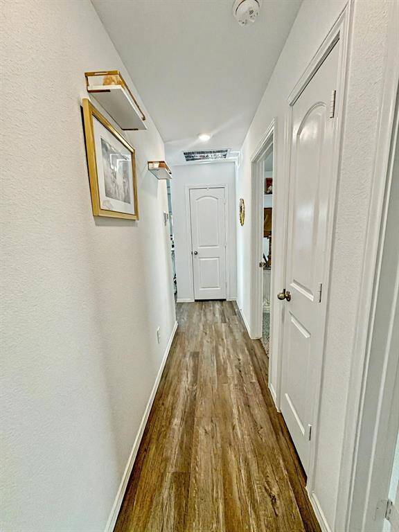 Hallway offers built in coat closet and linen storageSplit floor plan with other bedrooms separate from primary