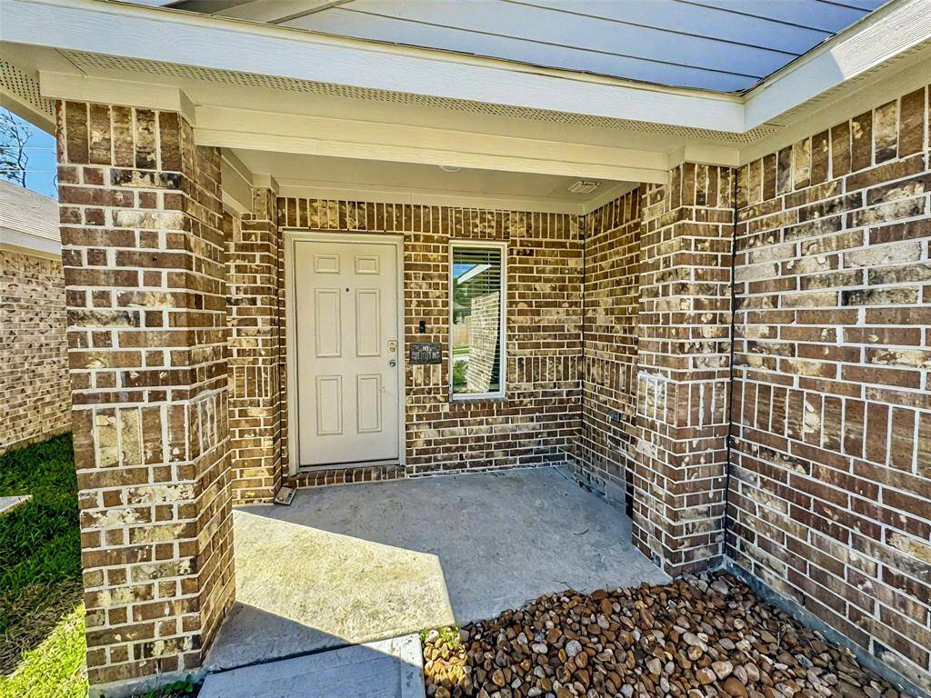 Covered porch entry. House is built with 3 sided brick and hardy plank.