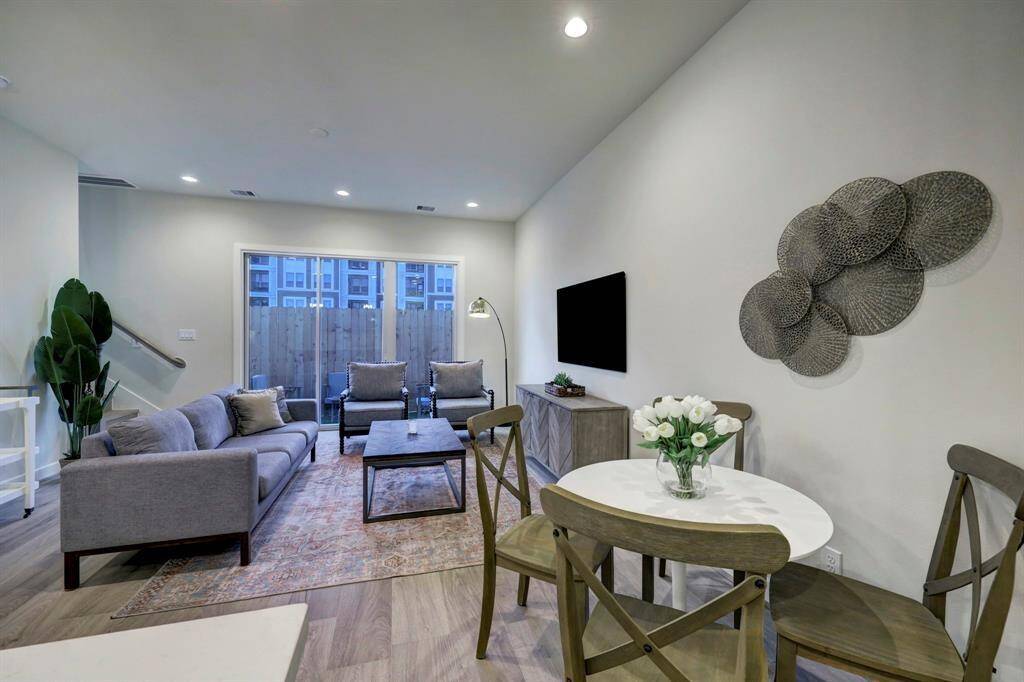 Generous family space exuding a welcoming atmosphere with a simple and light ambiance, perfect for hosting guests.