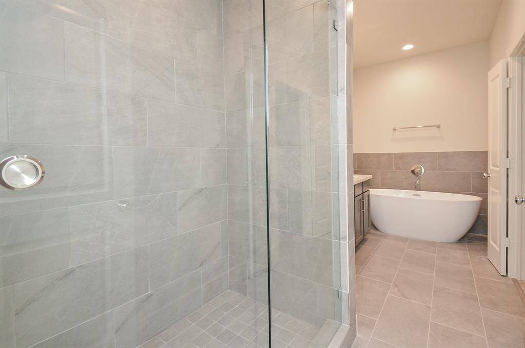 Explore perfectly organized bathrooms adorned with ample cabinetry and abundant lighting.