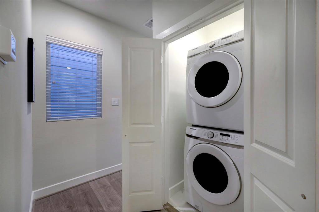 Tailored utility room designed to accommodate a washer and dryer.