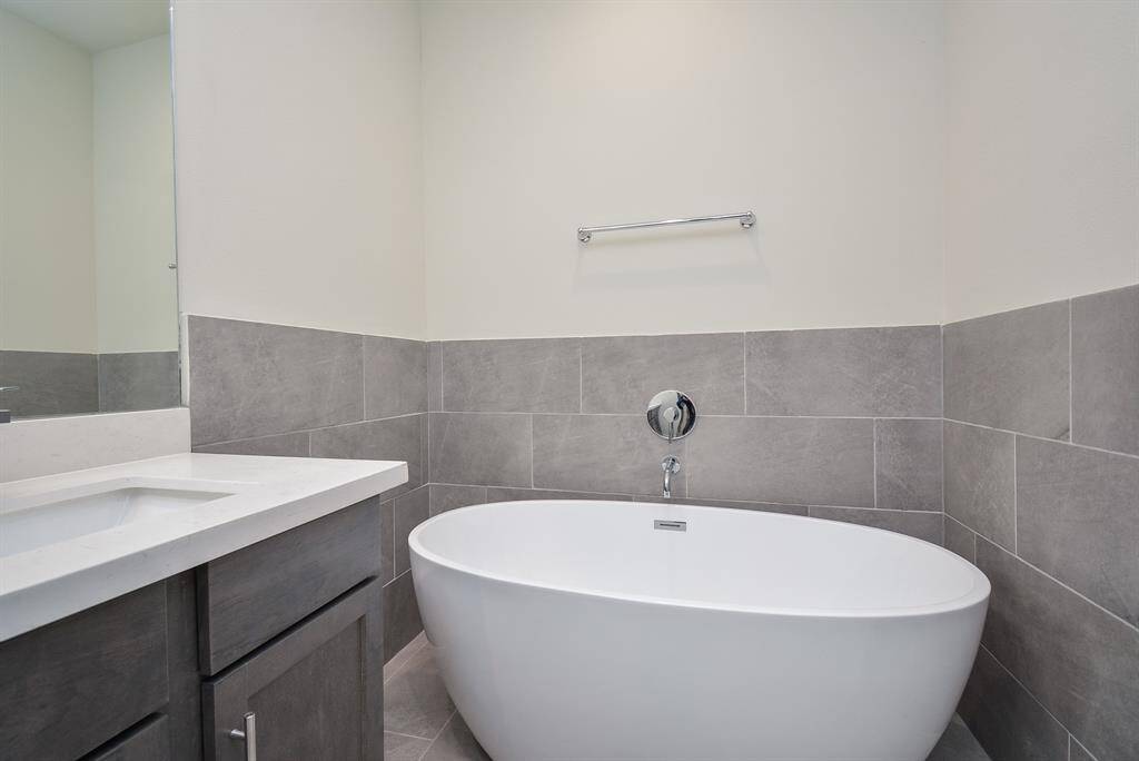 Explore perfectly organized bathrooms adorned with ample cabinetry and abundant lighting.