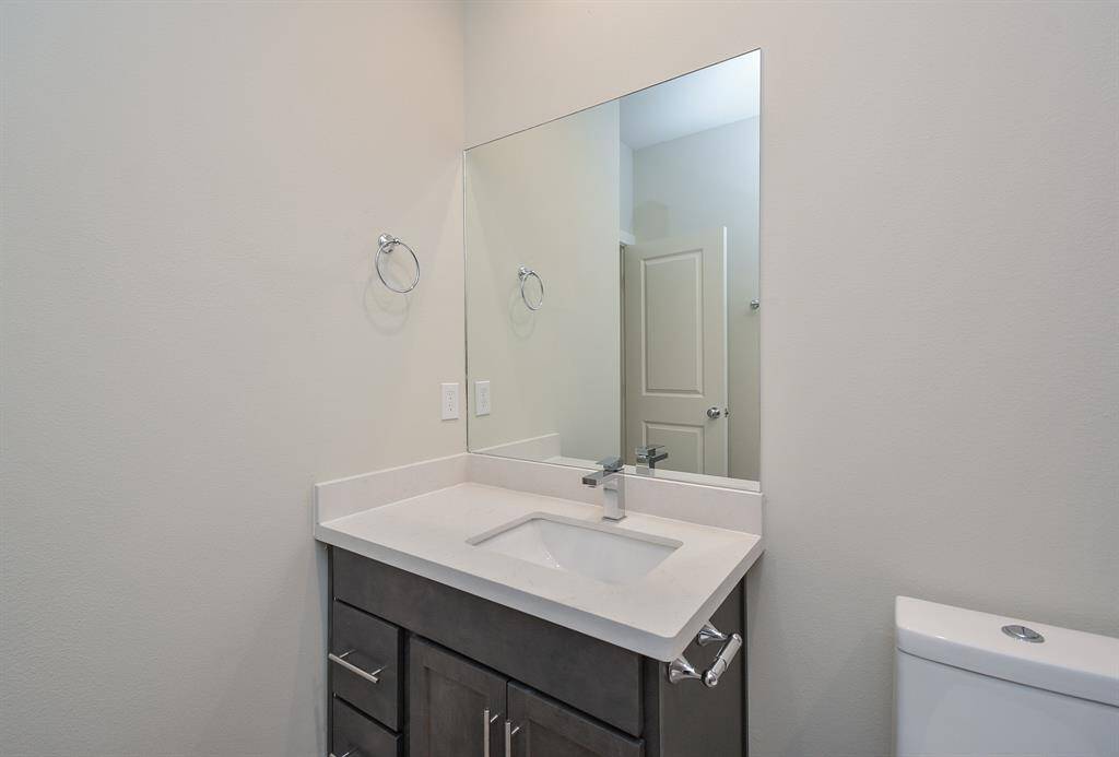 Explore perfectly organized bathrooms adorned with ample cabinetry and abundant lighting.