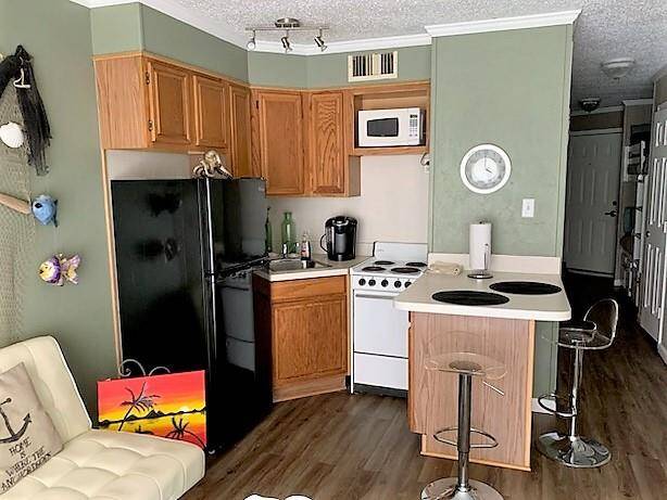 Kitchen open to living room and balcony