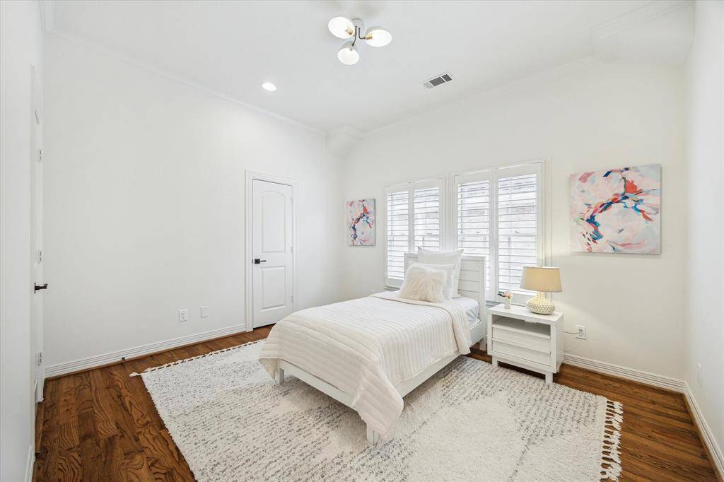 [Secondary Bedroom with Ensuite Bathroom] One of the three secondary bedrooms - all bedrooms are generous in size with hardwoods and shutters.