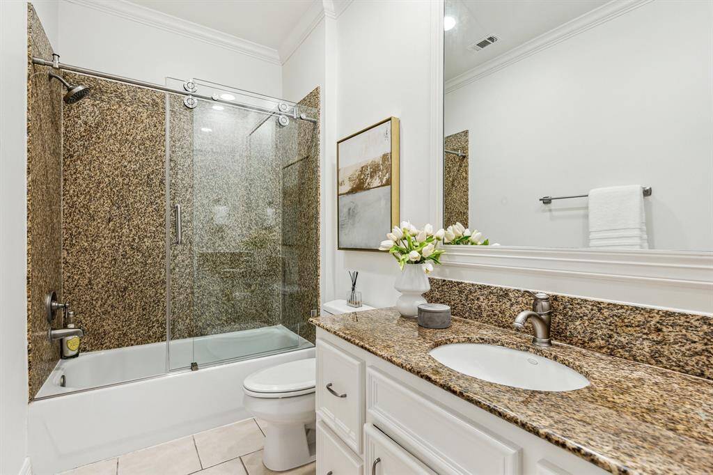 Ensuite bath with granite counter and granite bath surround. Floors are porcelain tile.