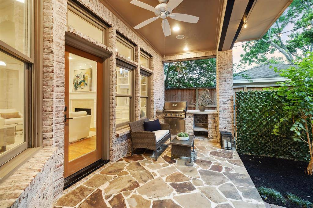 Enjoy year-round outdoor living with a covered patio with built-in grill and fan—perfect for al fresco dining and weekend gatherings.