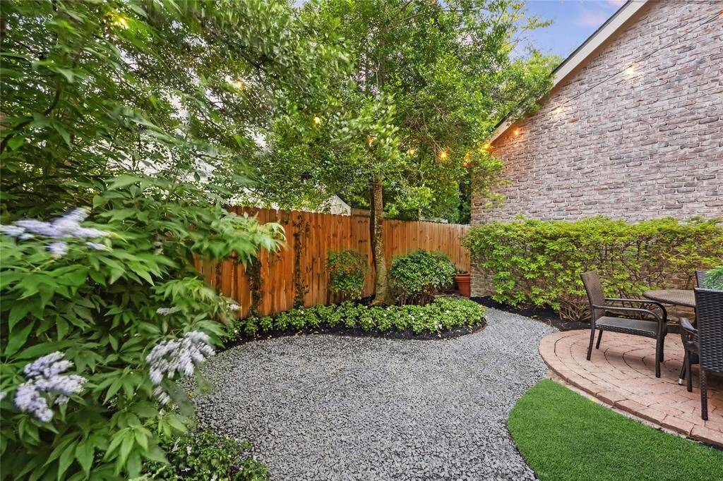 [East Elevation] Beautiful mature landscaping overlooking back yard. Low maintenance, shaded and pavered backyard with sprinkler system. Floored attic above the garage.