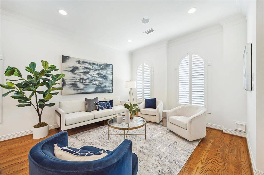 [Formal Living] View of the formal living room from the foyer. A curated space to entertain guests, display your art collection, and relax with a glass of wine. Views of the front gardens. Recessed lighting.