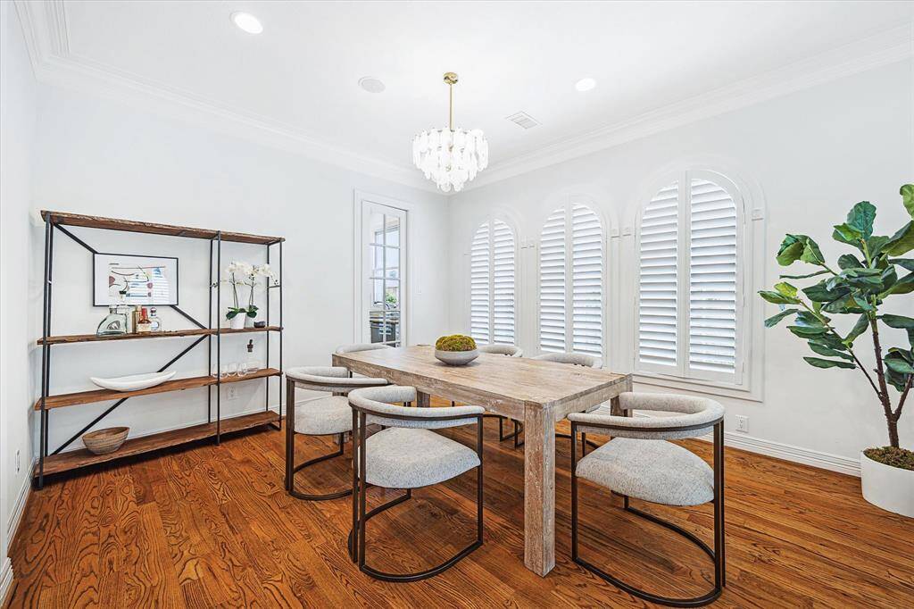 Dining room has access into the kitchen and the door provides privacy when desired. Brass chandler. Hardwoods throughout.