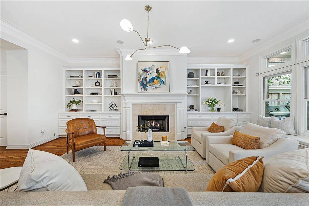 [Family Room ] The expansive family room boasts views of the backyard, with a fireplace with marble surround and hearth that serves as an instant focal point. Notice the bench seat under the windows. It s built-in with  drawer storage underneath.