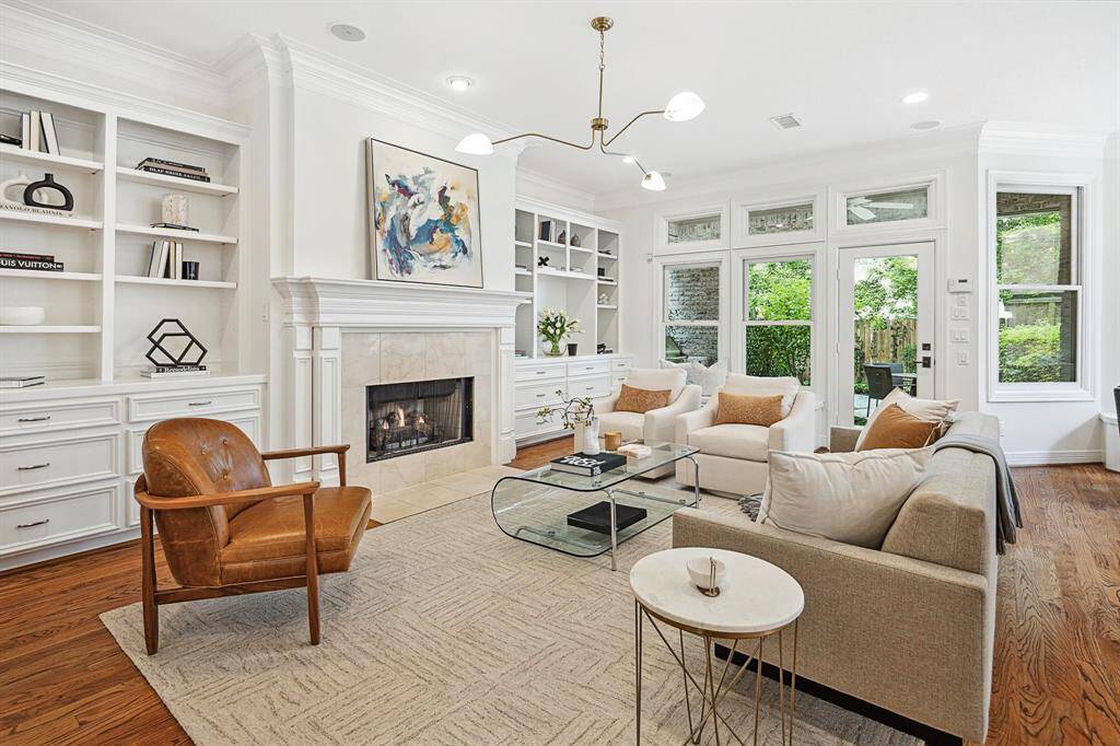 A series of picture windows across the back of the family room beautifully blend the indoors with outdoors. It seamlessly floods the space with lots of natural light and expands the living spaces.