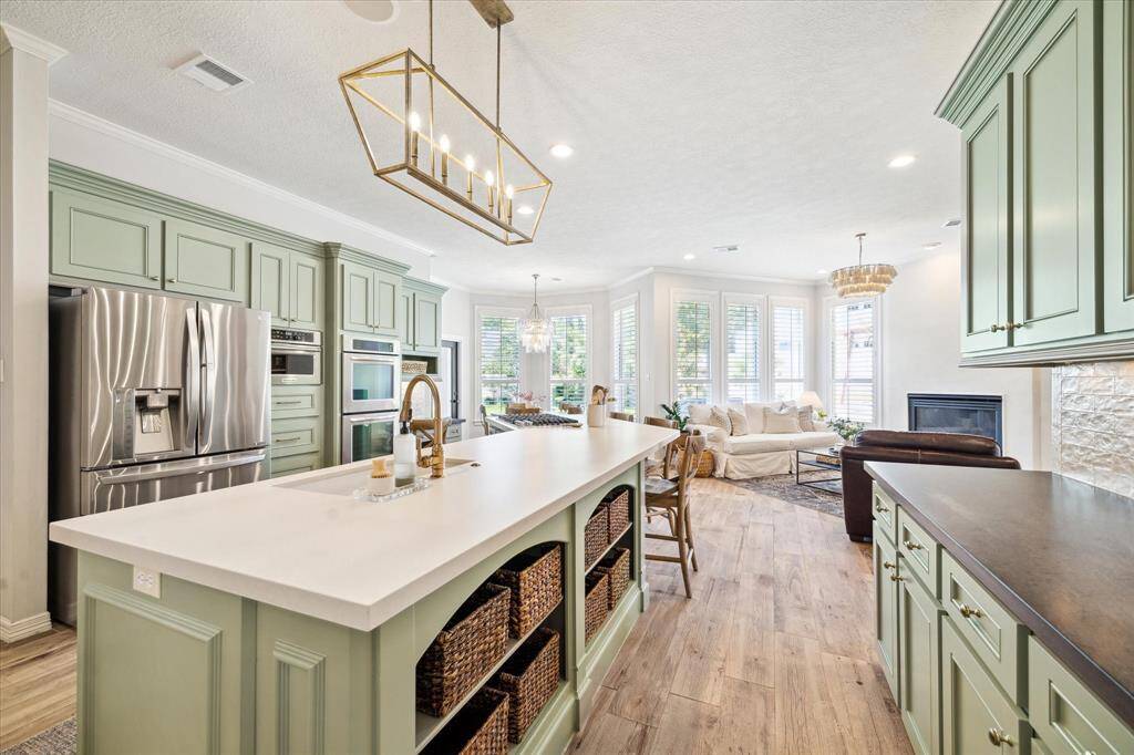 Entertainer’s Kitchen – Bright and open with bar seating and views of living areas.