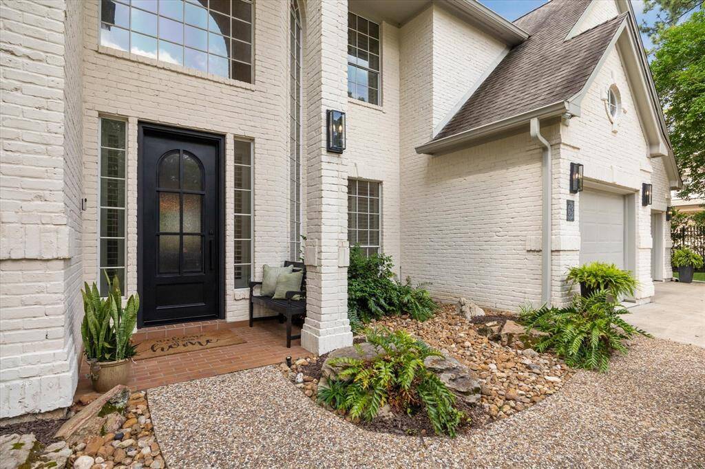 Charming Entry – Covered front porch with striking iron door and fresh exterior paint.