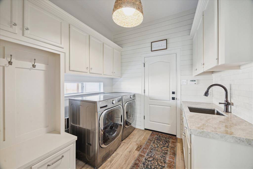 Functional Mudroom – Laundry room with built-in storage and shiplap accent wall.