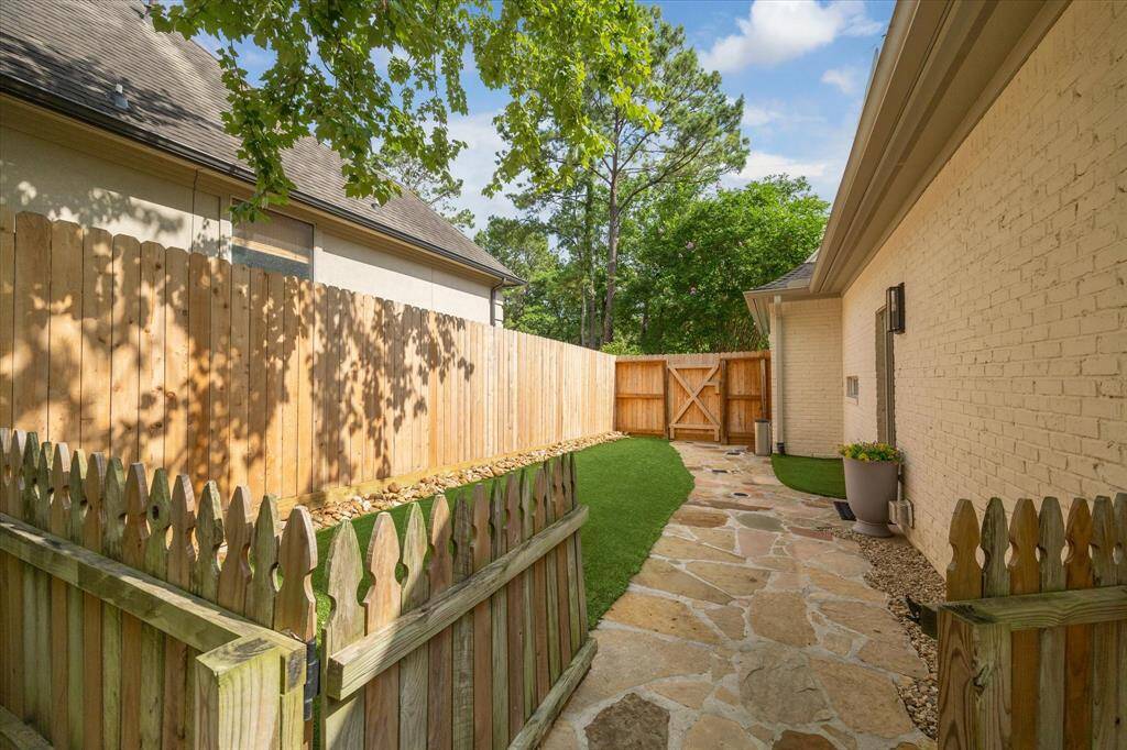 Pet-Friendly Bonus – Side yard dog run with turf—ready for four-legged family members.