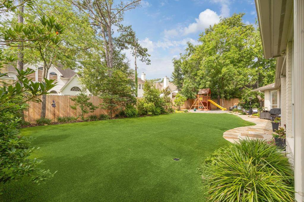 Backyard Fun – Tree Frogs playset (stays!) and turf yard for year-round play.