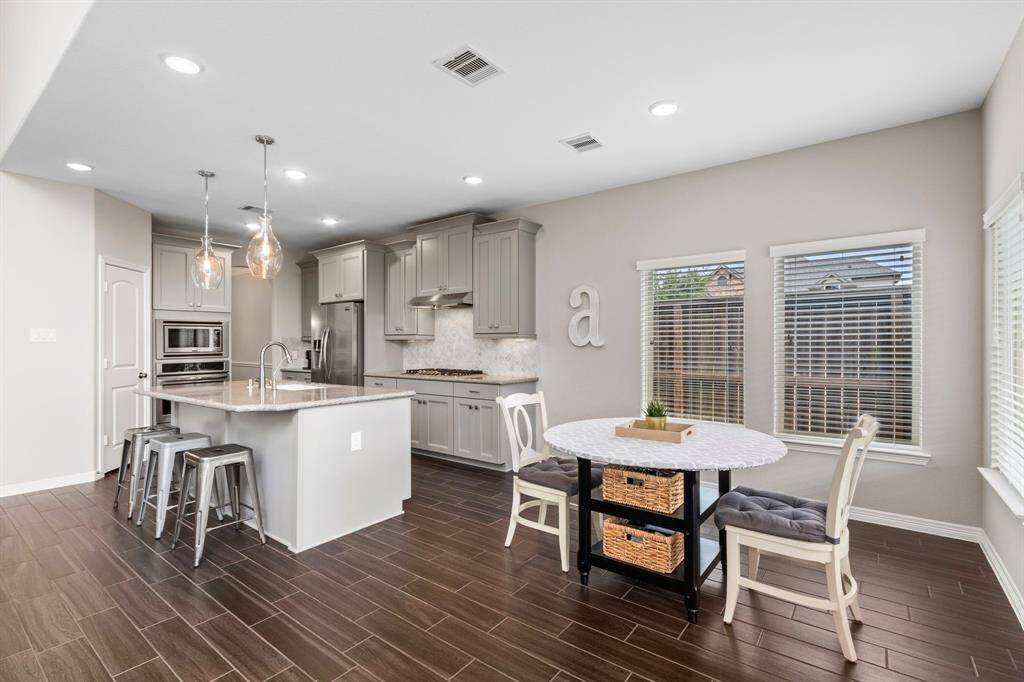 Do you prefer to have your causal meals at the table or the island? The beautiful and durable hardwood floors flow through all of the public spaces on the first floor, giving this large home an even grander visual impact. Don't miss the corner pantry when you visit the home in person.