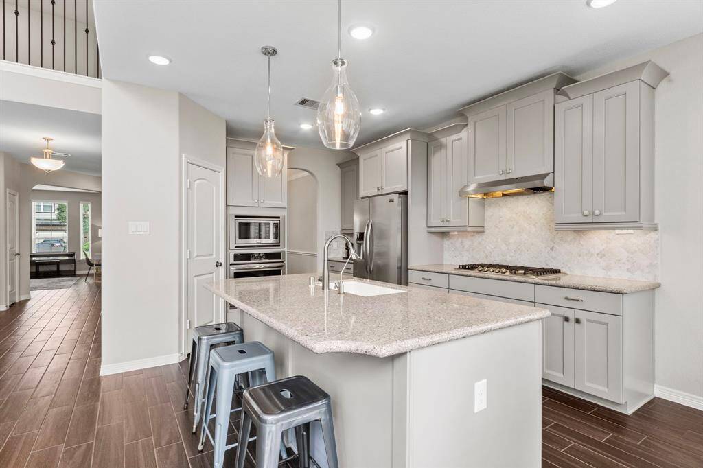 Whether grabbing a quick bite or working on homework, the kitchen island provides bar seating for 3-4 and could also be used for buffet or charcuterie-style serving during large gatherings.