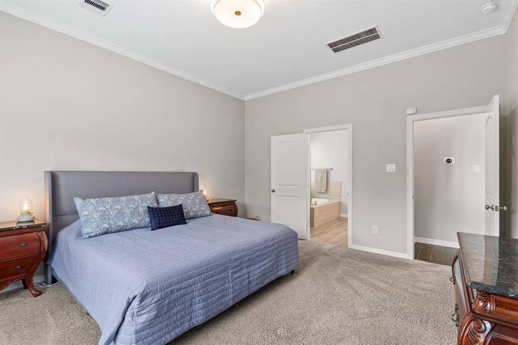 A view from the primary bedroom to the private suite entry and bathroom. This room is proportioned for King-sized furnishings.