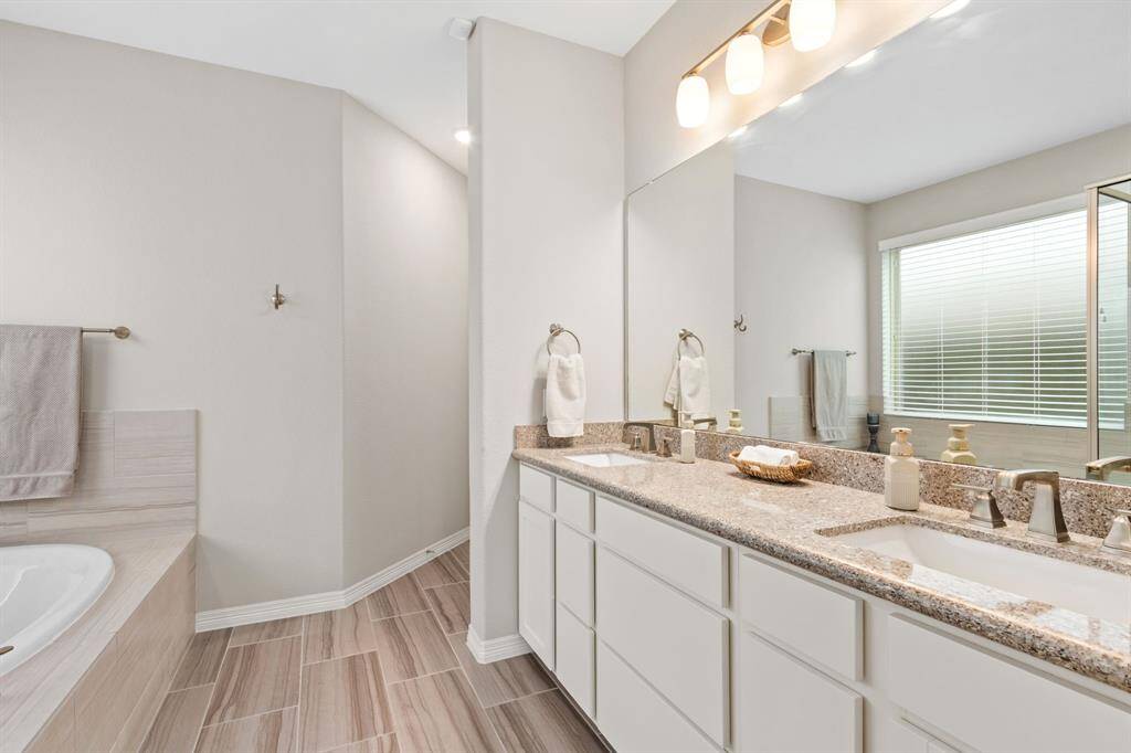 Double sinks, ample storage, and upgraded fixtures and tile selections combine to create a relaxing environment as you get ready to greet the day!