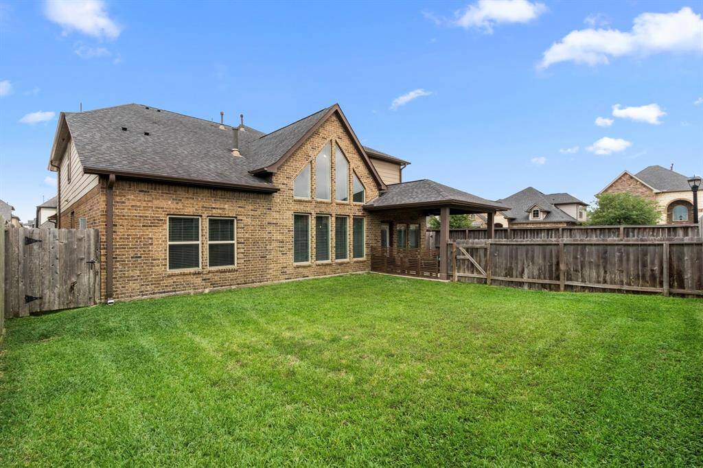 This is the yard space beyond the mini dividing fence. There is room here for all of your future plans...and the grass is in great condition to kick off summer outdoor entertaining!