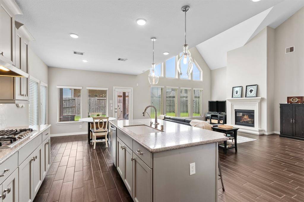 Upgraded cabinetry, lighting, and hardware blend seamlessly with the design aesthetic of the overall home, making the kitchen a space that is both highly functional and attractive.