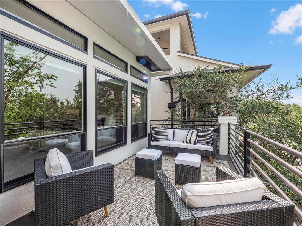 This inviting primary balcony features attractive railings and amazing views of the park.