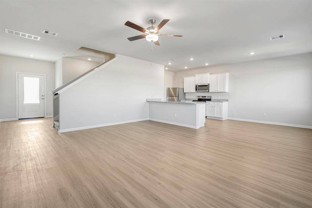 Spacious living room, open to the kitchen and dining area.