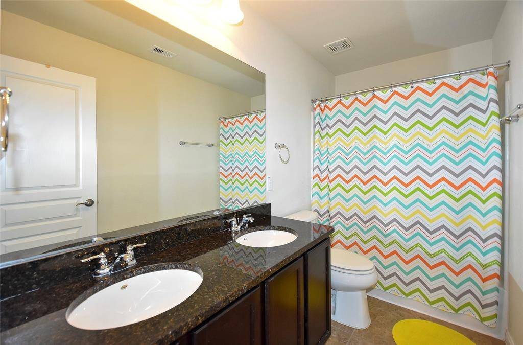 Full bathroom upstairs with double sinks, shower/tub.