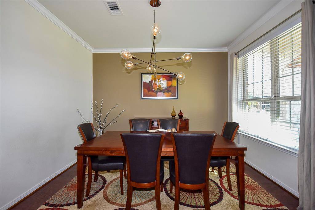 Formal dinning room with modern accent wall.