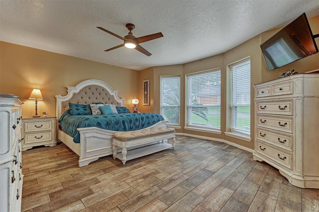Primary Suite located on 1st floor! Wood-look tile floors & gorgeous windows