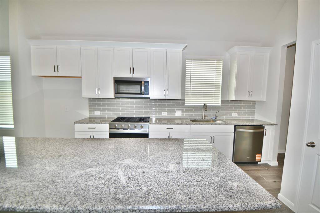 The kitchen features granite countertops.