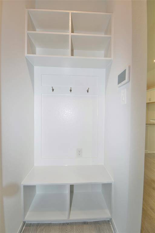 The built in shelving by the garage door is perfect for storage
