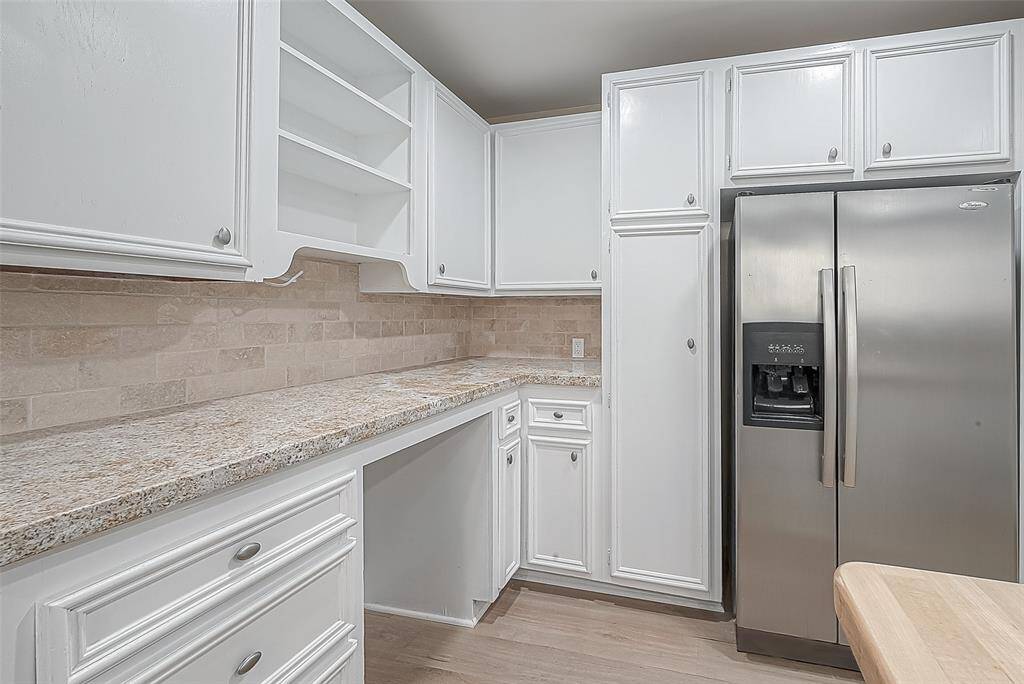 So many cabinets! Pantry cabinets on either side of the fridge provide ample space for food storage.