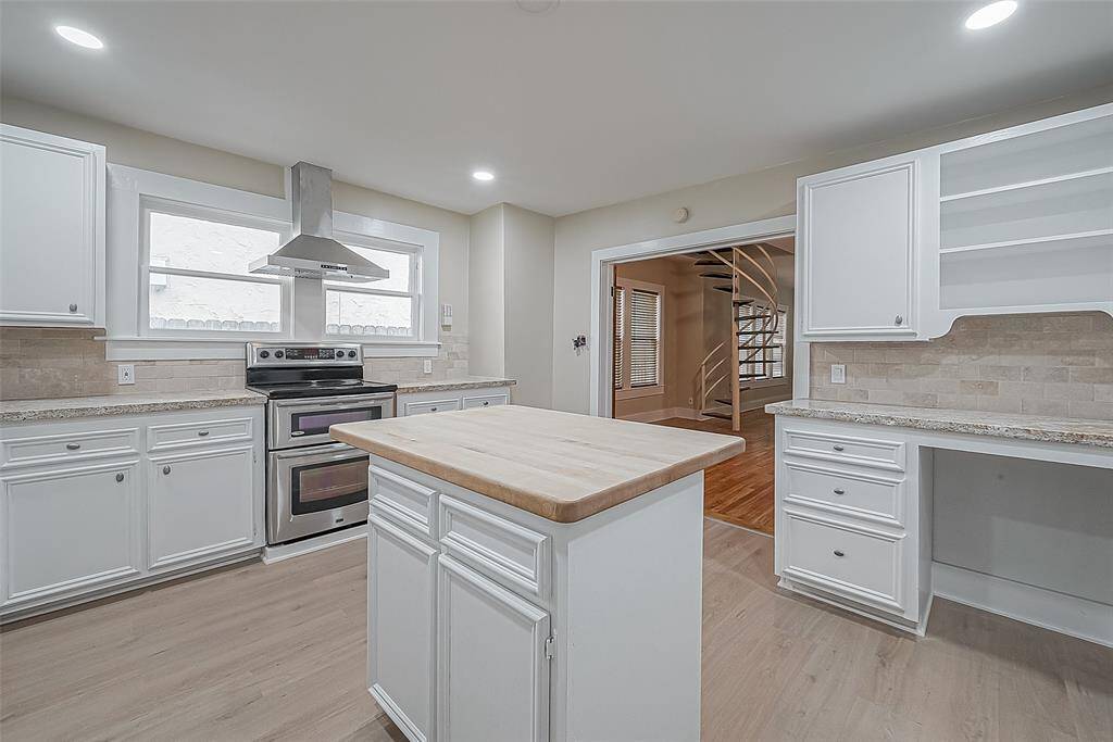 Great view of the kitchen, looking back toward the range and living/dining.