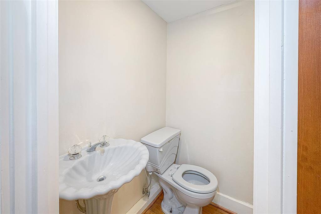 The half bath in the primary bedroom includes a pedestal sink and toilet.