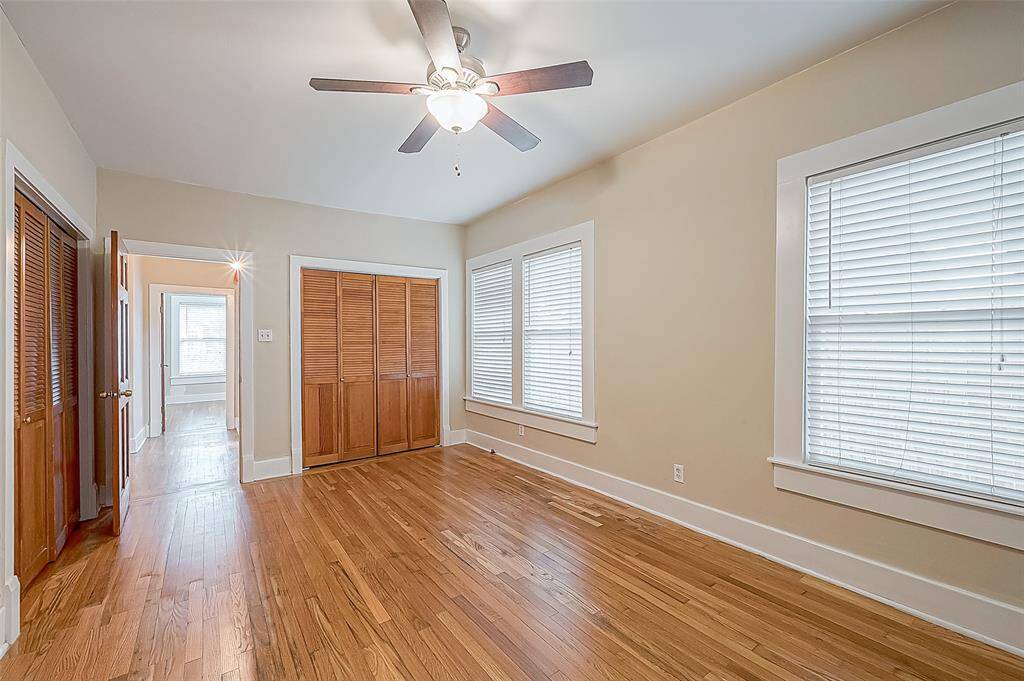 Taken from the far end of the room, this photo shows the second double closet and gives you an idea of how many windows there are!