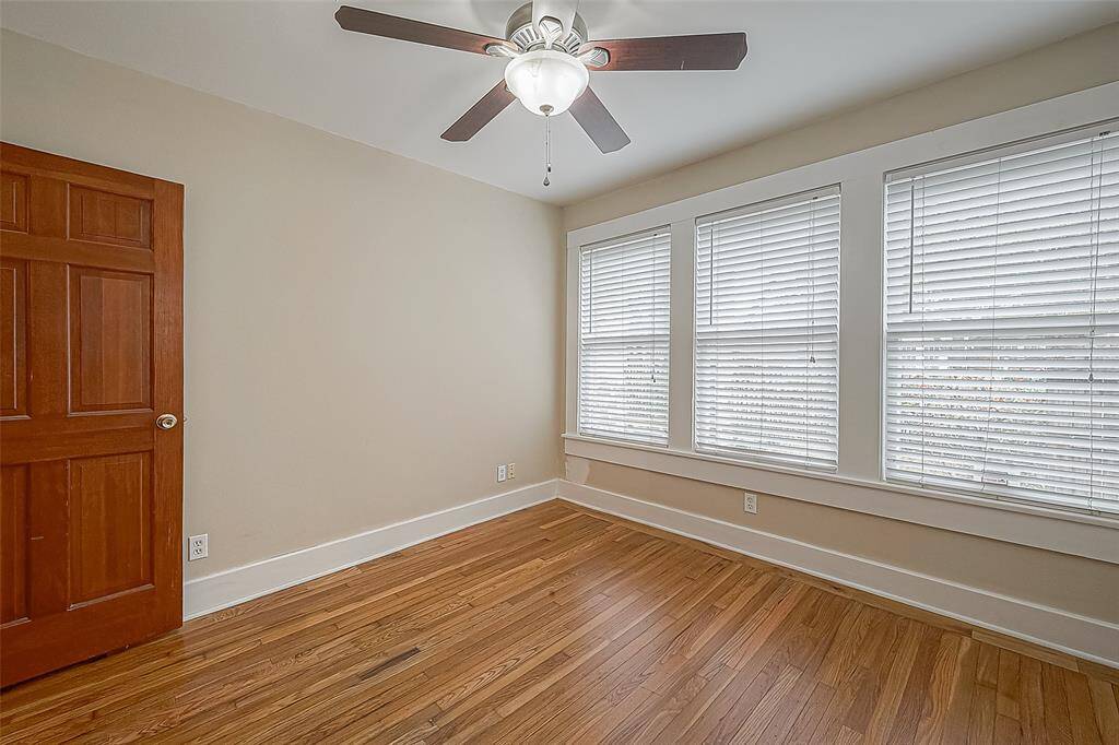 The front bedroom also features wood floors and ceiling fan.