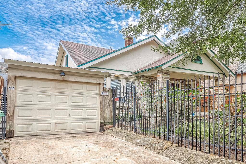 Attached to the house is a long carport, with this automatic garage door for easy entry.