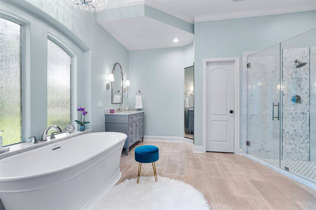 The primary bathroom features a huge walk-in shower with tile surround and soaking tub.