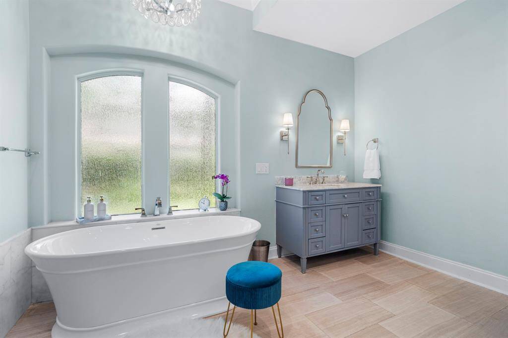 The separate tub is perfect for relaxing while next to the frosted windows and below the chandelier!